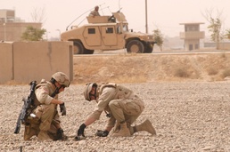 SGT Taul and SFC Robar inspect a 57-mm rocket that they found