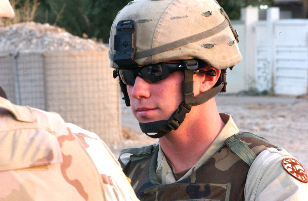 SPC Douglas on Guard Duty talking to an Army Reporter