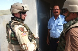 LT Brillhart talks with an Iraqi Police Officer