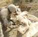 a Soldier digs up a weapon cache