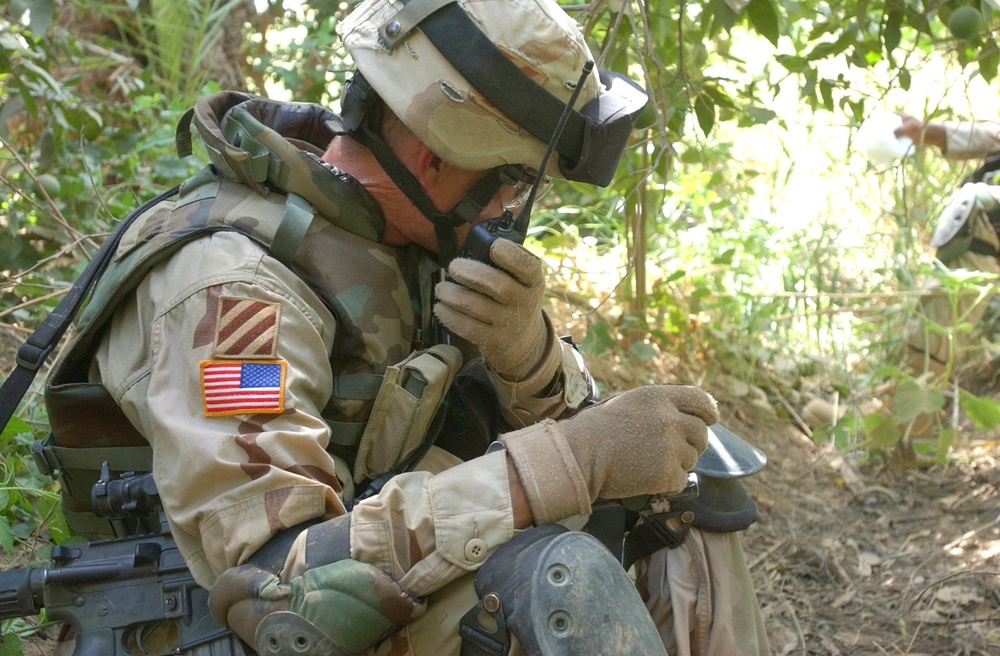 Sgt. 1st Class Bush radios his men