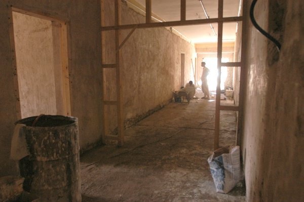 Two Iraqi workers prepare tile for installation