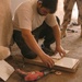 An Iraqi worker prepares a tile