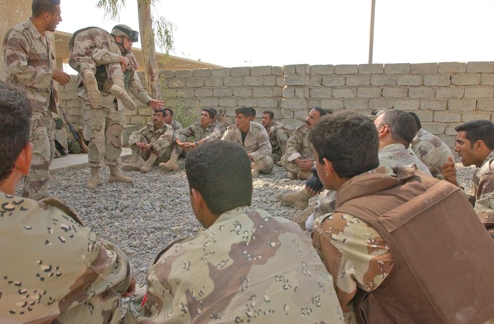 Spc. Dominic Italiano teaches an Iraqi combat life saver class