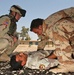 Spc. Hardwick watches as an Iraqi soldier practices assessing a casualty