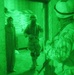 Iraqi Soldiers escort an Iraqi woman out of a room in her home prior to sea
