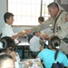 Staff Sgt. Mario Alfaro  hands out school supplies