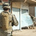 Sgt. Brooks peels back an unsecured door of a business in Tall Afar