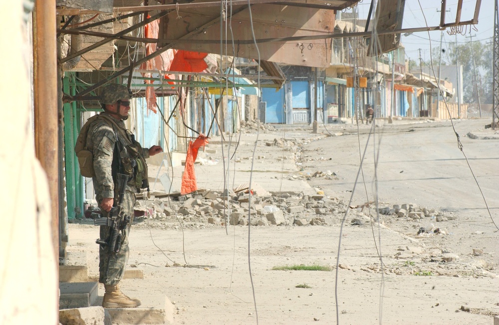 Lt. Col. Gibson stands in the shade during a break