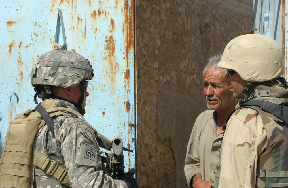 Capt. Adamczyk speaks with a resident of Tall Afar