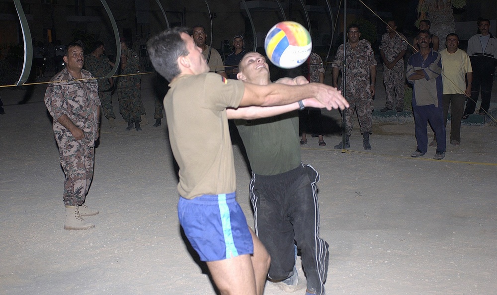 Two German soldiers collide while trying to hit the ball