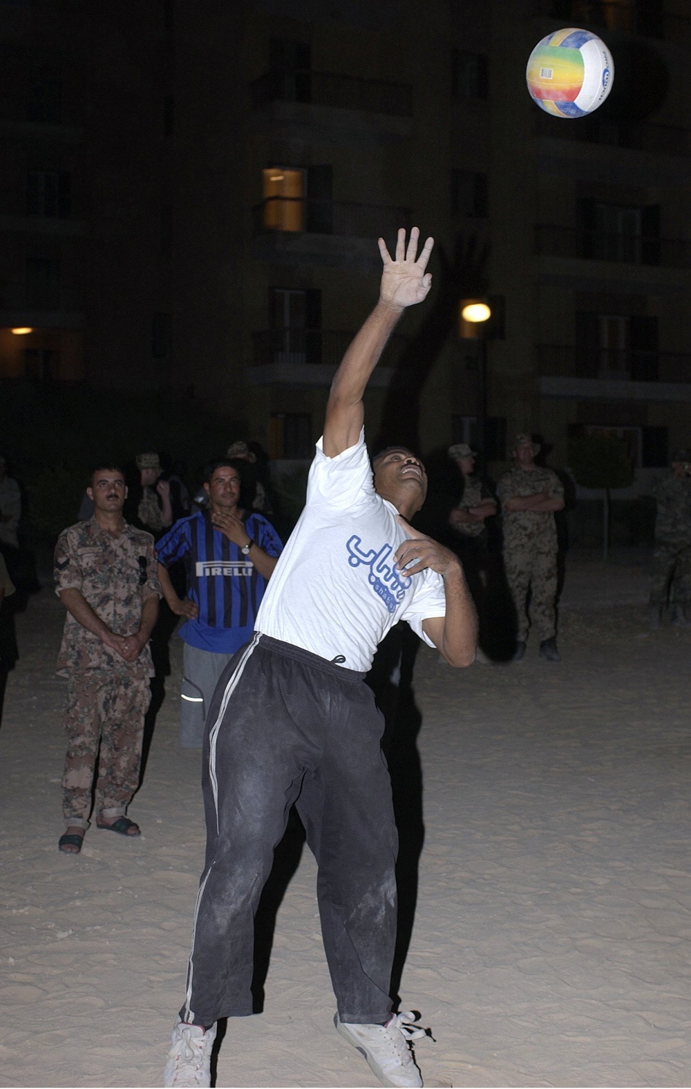 A Jordanian soldier serves the ball