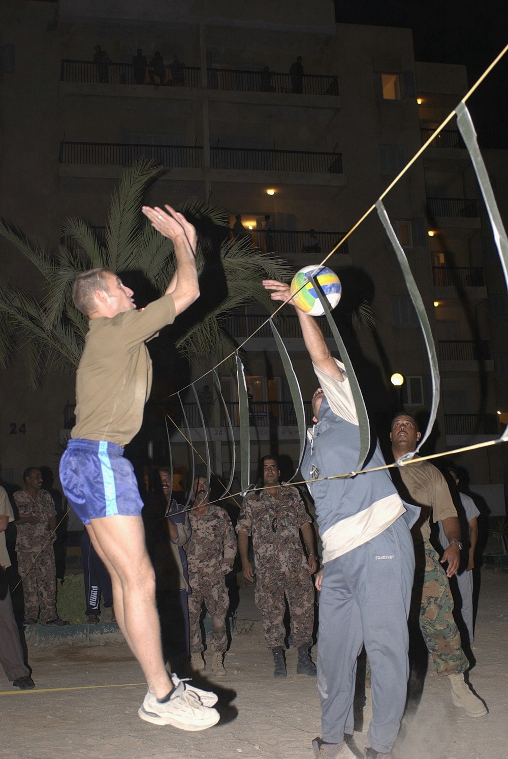 A German player blocks a spike from a Jordanian front-lineman