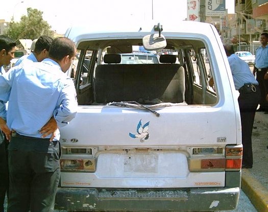 Iraqi Police inspect a car bomb