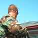 Soldier uses a pole to break through a window