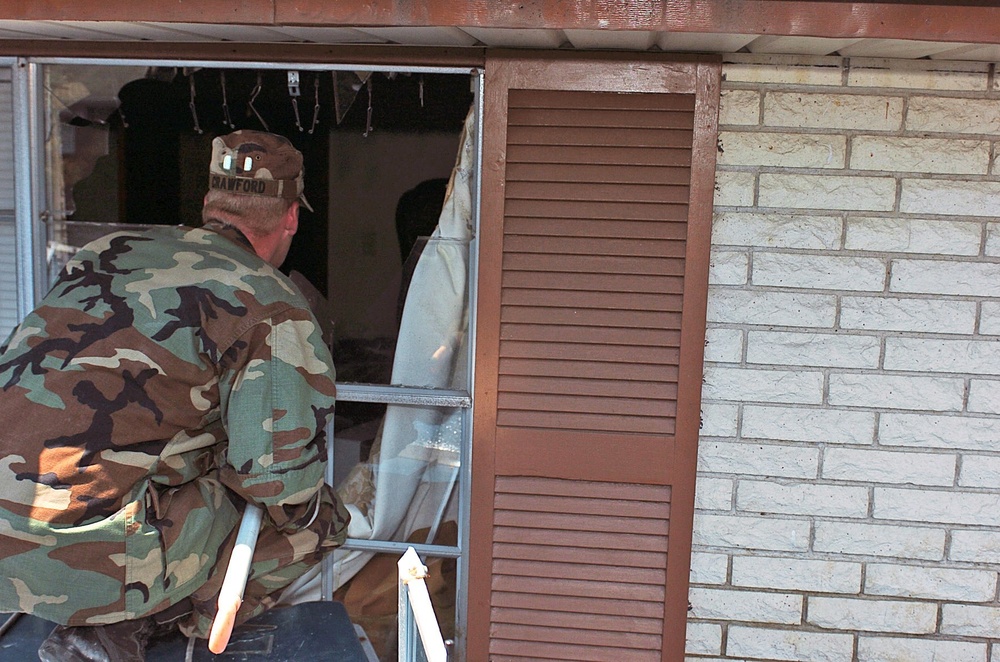 A Soldier searches a house