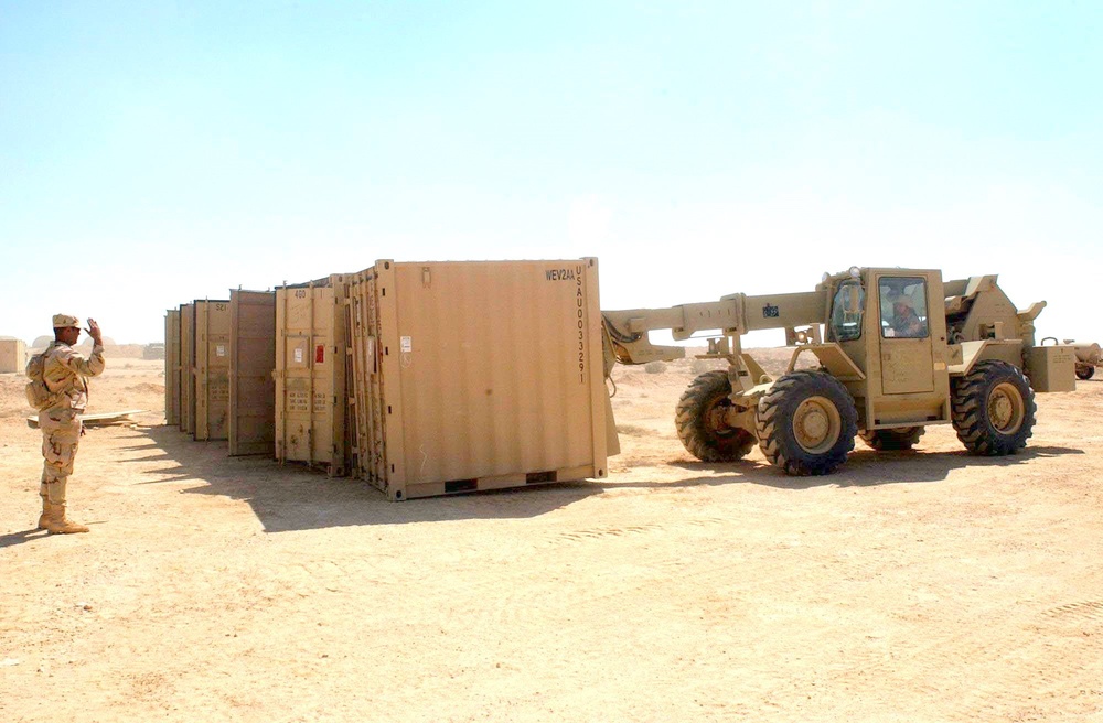 A forklift lines-up storge units