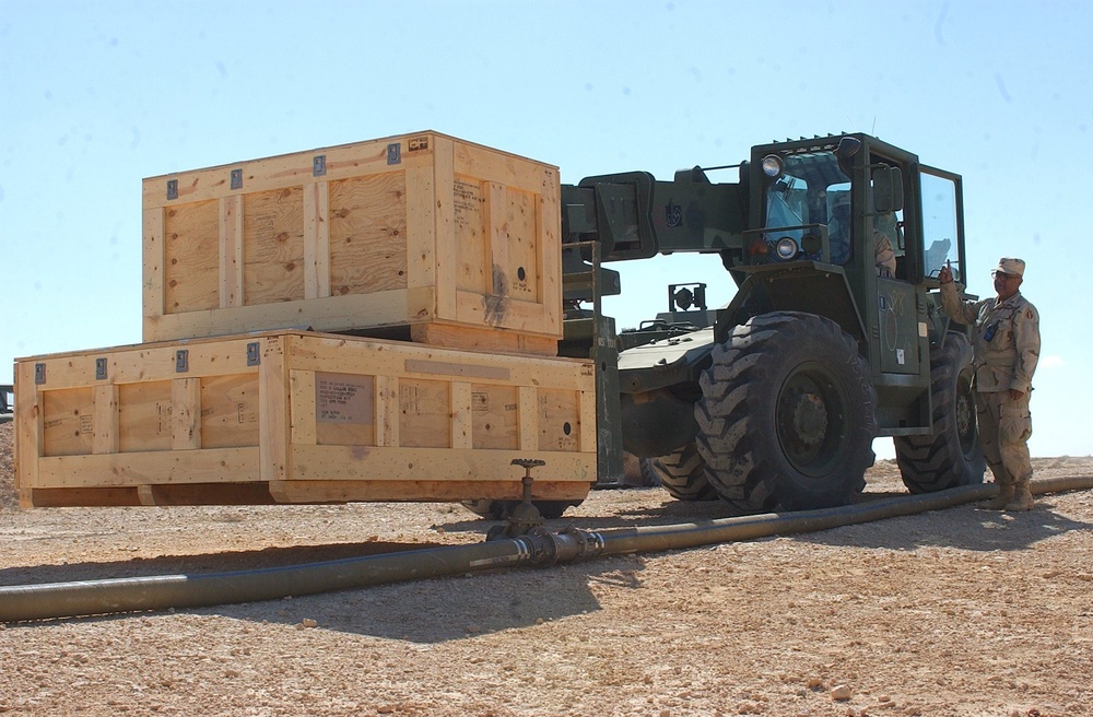 US Soldiers position crates of equipment