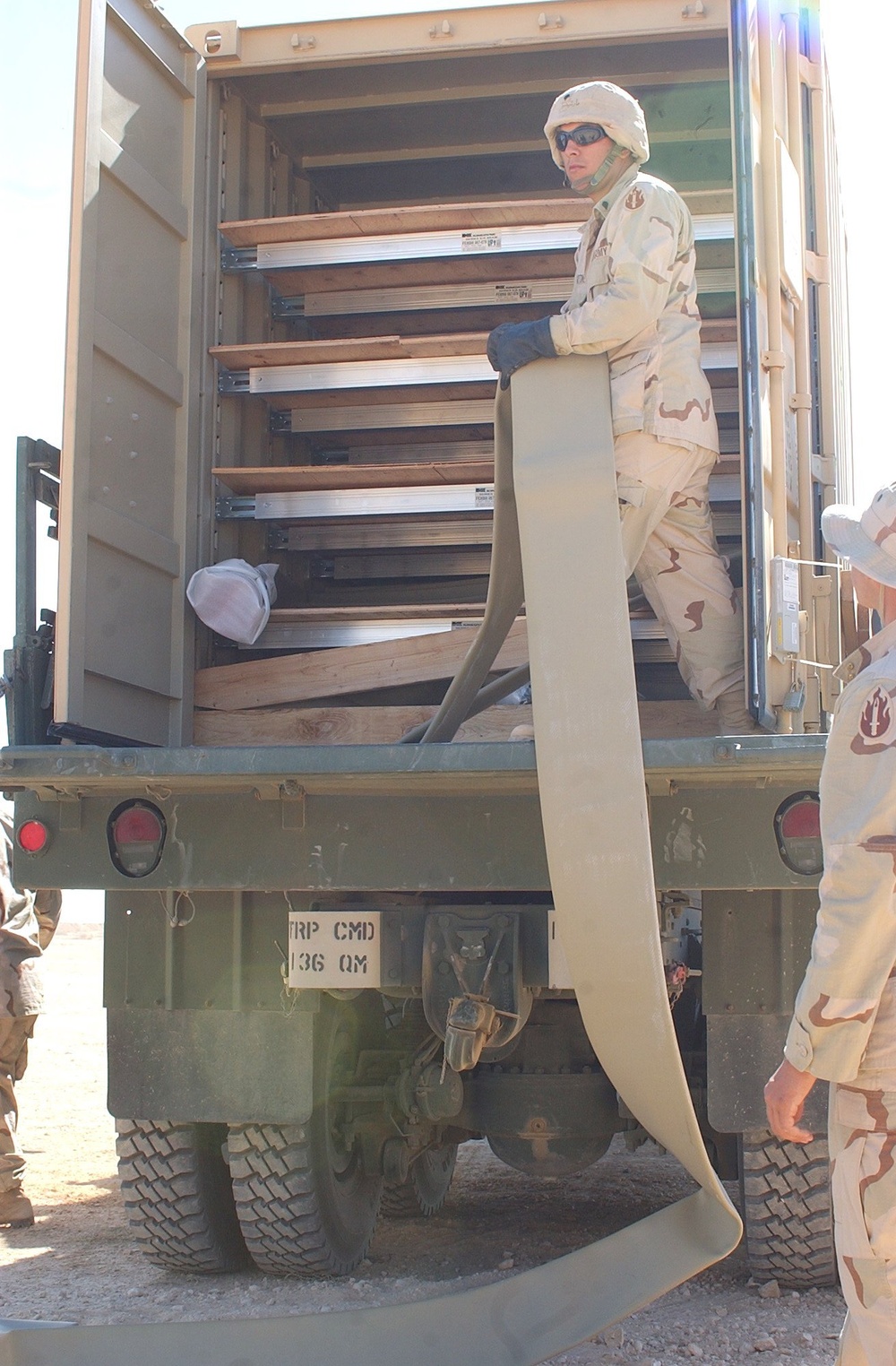 US Soldiers unload hoses and other equipment