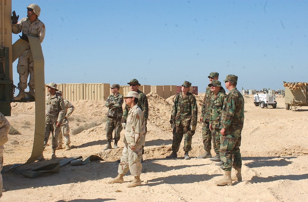 US Soldiers unload hoses and other equipment