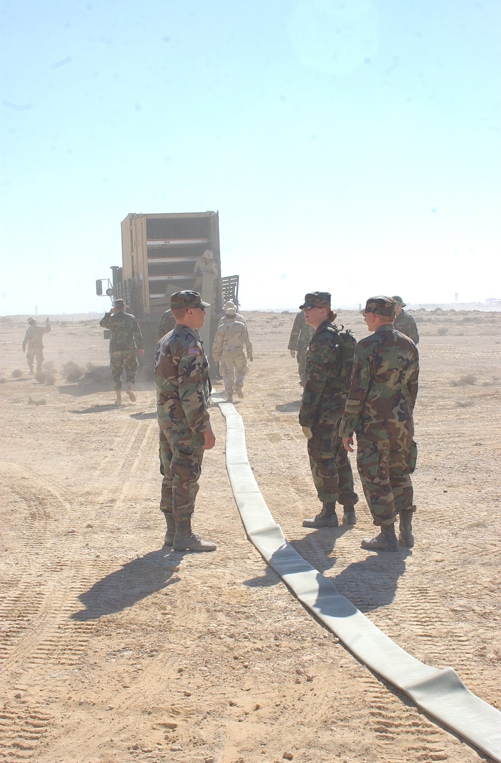 US Soldiers unload hoses and other equipment