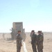 US Soldiers unload hoses and other equipment