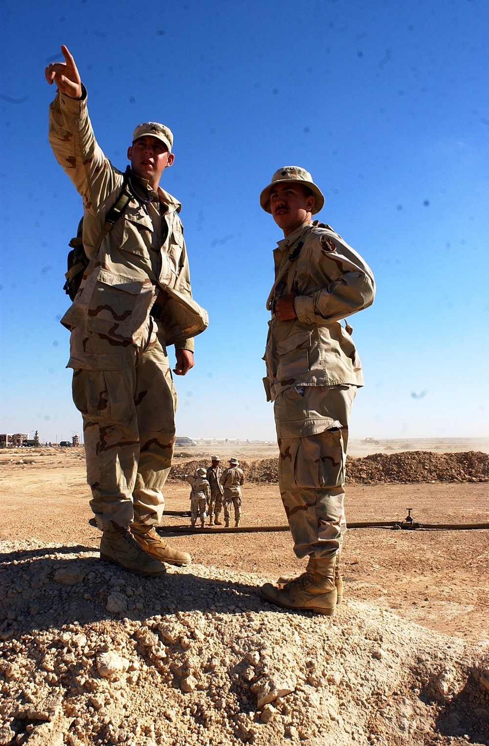 US Soldiers survey a construction site