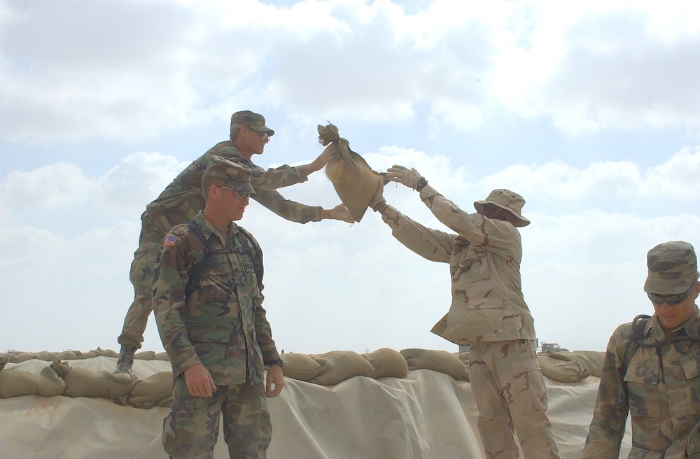 US Soldiers place sandbags at a fueling point