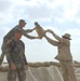 US Soldiers place sandbags at a fueling point