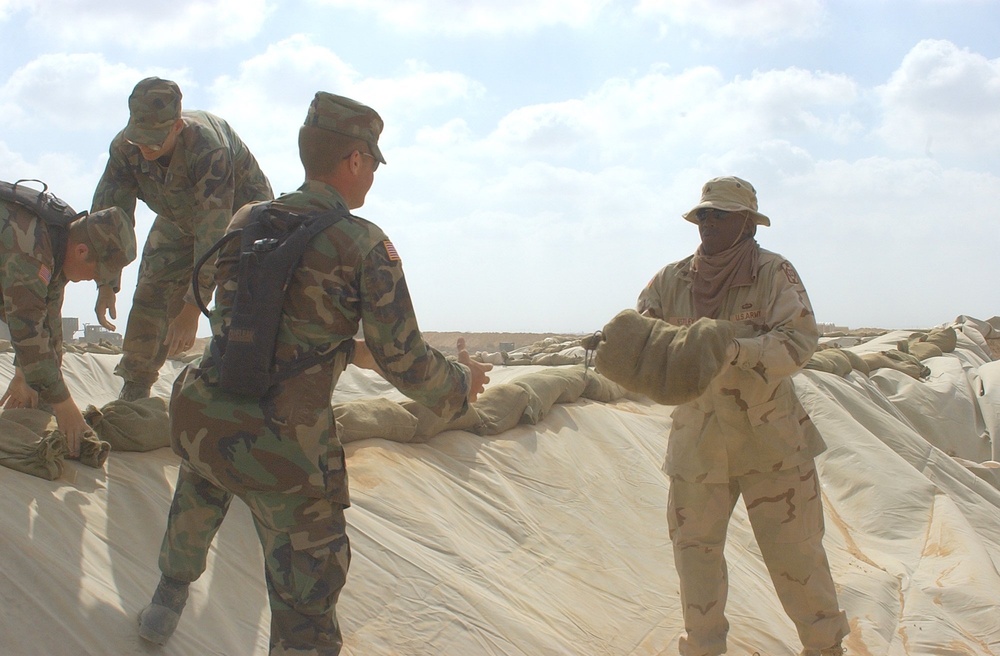 US Soldiers place sandbags at a fueling point