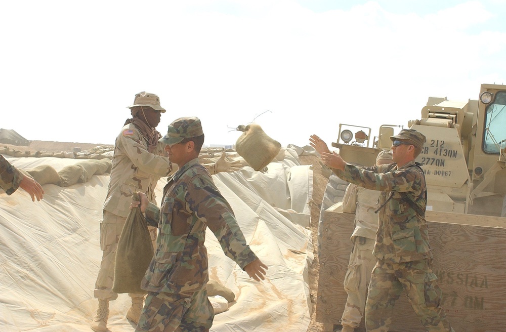 US Soldiers place sandbags at a fueling point