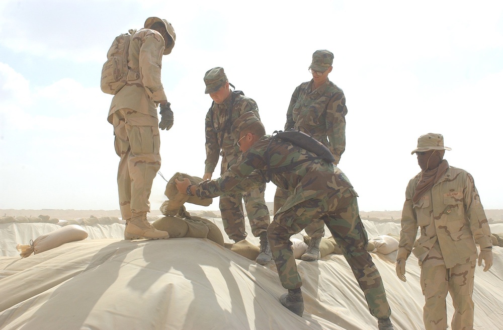 US Soldiers place sandbags at a fueling point