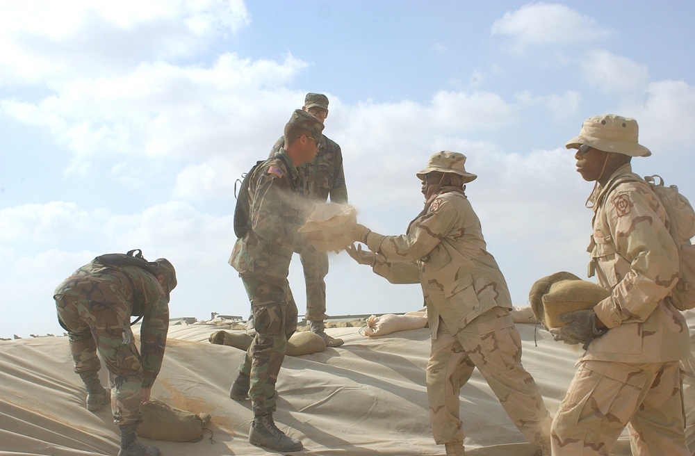 US Soldiers place sandbags at a fueling point