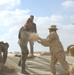 US Soldiers place sandbags at a fueling point