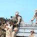 U.S. Marines load their excess gear unto a truck