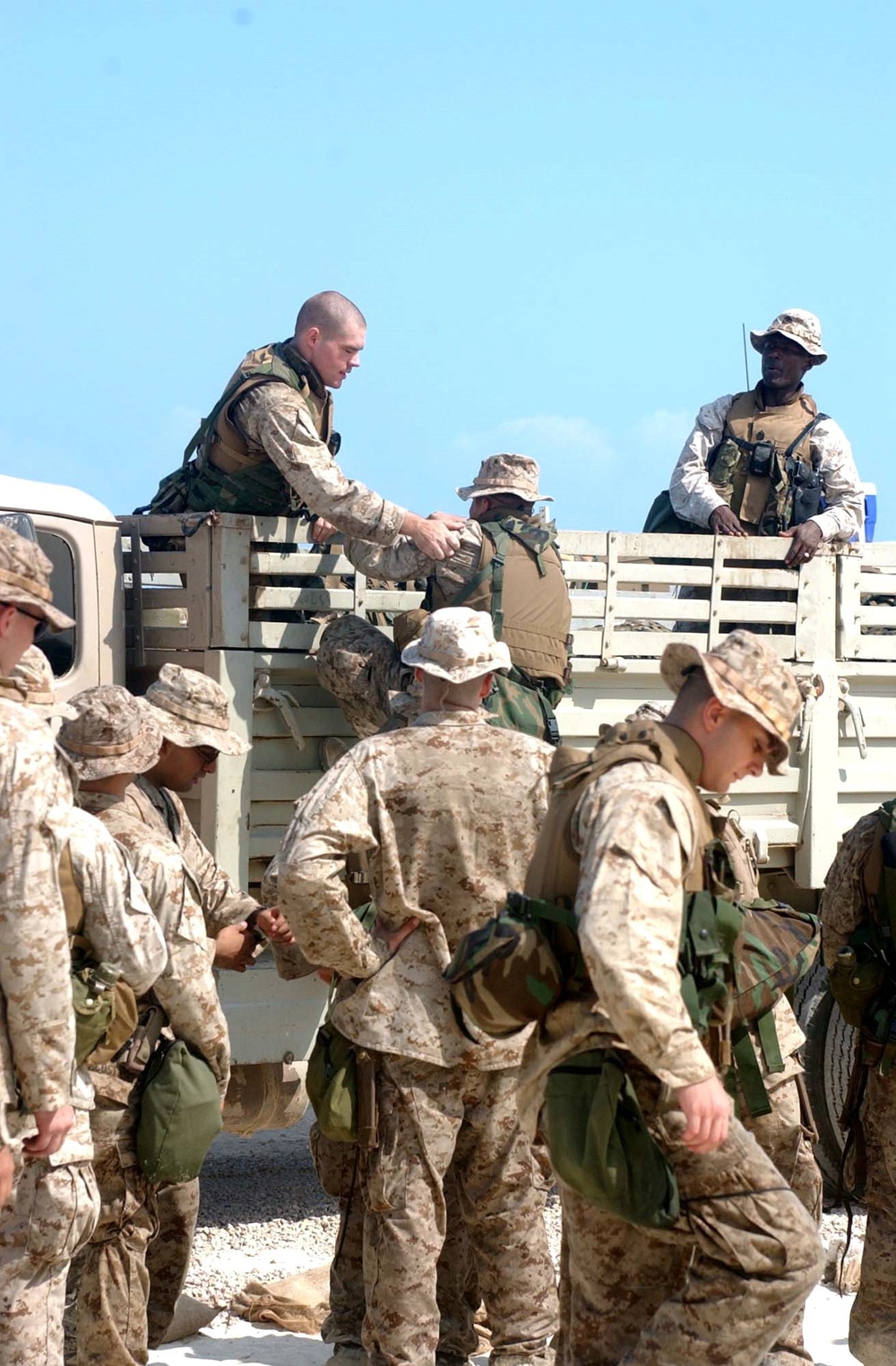 U.S. Marines load their excess gear unto a truck