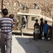 A local resident of Tall Afar carries his young son to an awaiting HMMWV