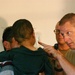 Maj. Ben E. Solomon shows a small boy that he wants to examine his eyes