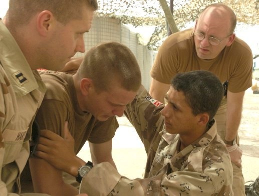 Medics and chaplain console a Soldier