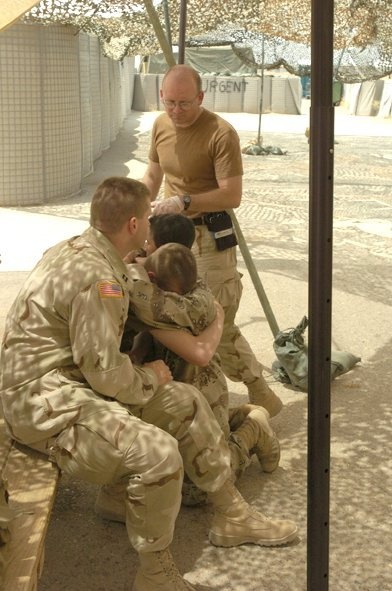 Medics and chaplain console a Soldier
