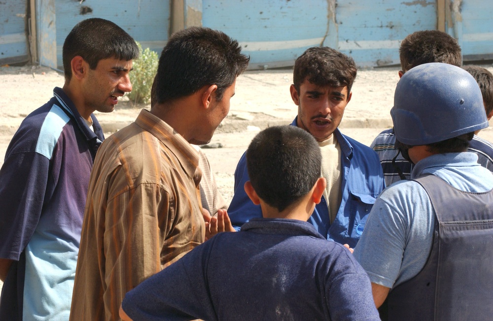 Residents of the war-torn city of Tall Afar, Iraq, crowd around Sindebad Ah