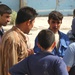 Residents of the war-torn city of Tall Afar, Iraq, crowd around Sindebad Ah