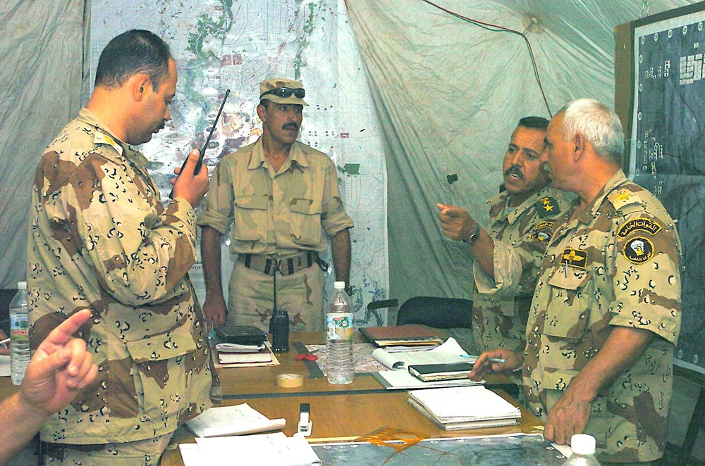 An Iraqi Lt. Col. directs fellow officers during a command post exercise
