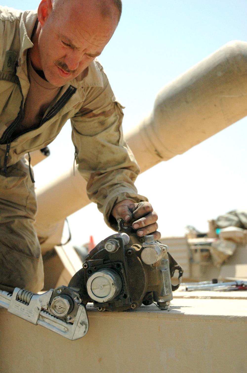 Staff Sgt. Hullet repairs a main hydraulic pump for an M1A2 Tank