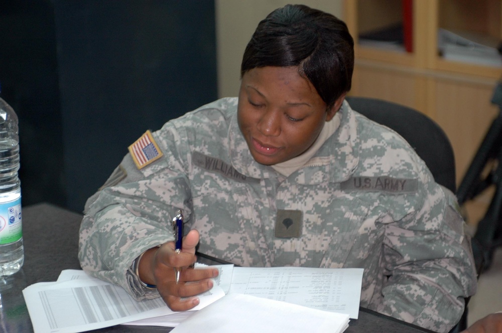 Spc. Williams reviews personnel rosters