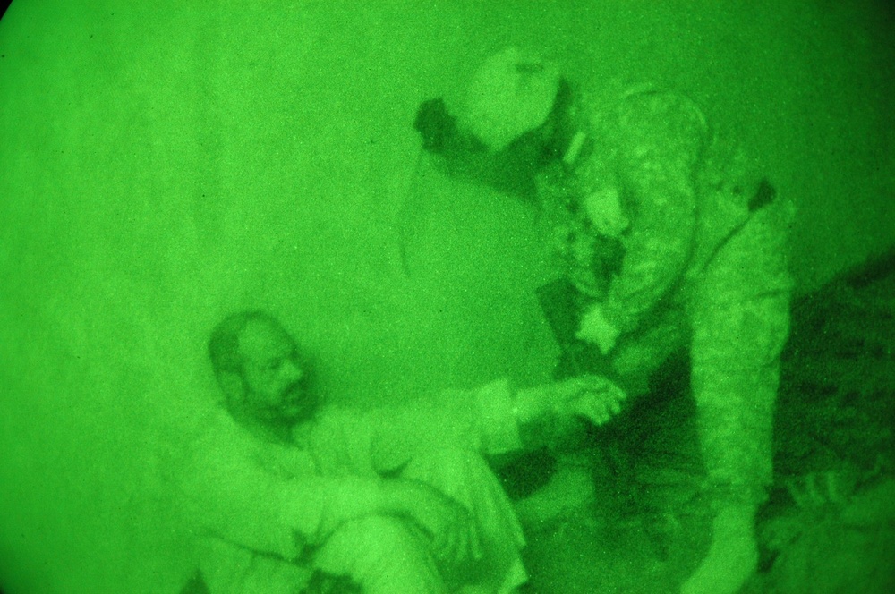 A medic provides assistance to an elderly Iraqi man