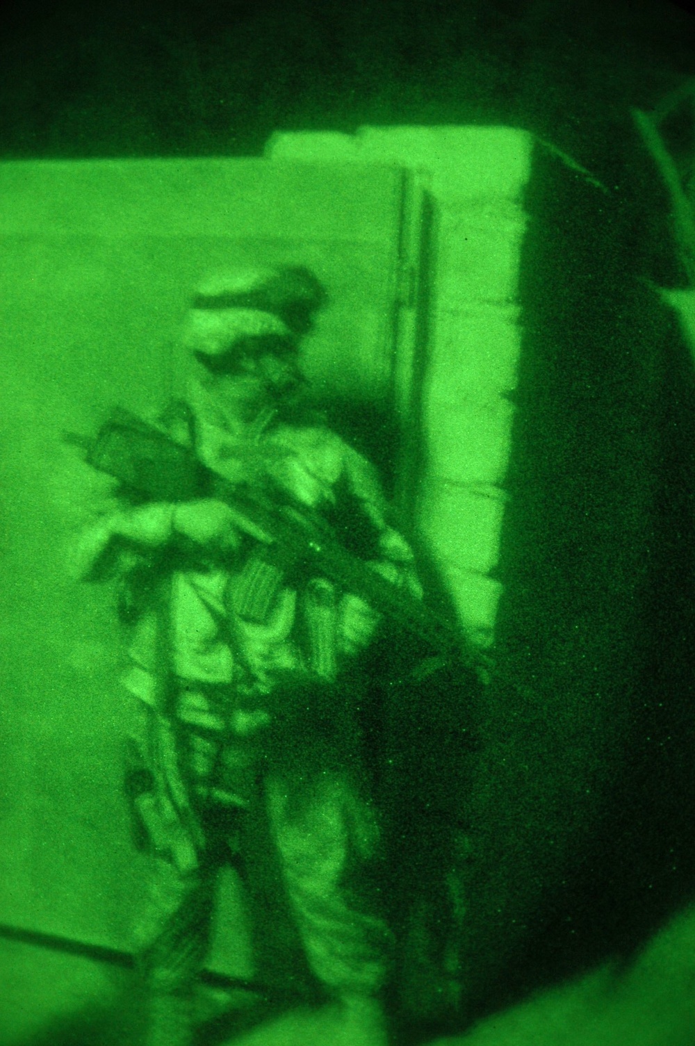 A Soldier stands watch during a night operation