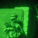 A Soldier stands watch during a night operation