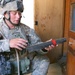 Spc. Kenneth S. Freeman examines a rolled up paper he found