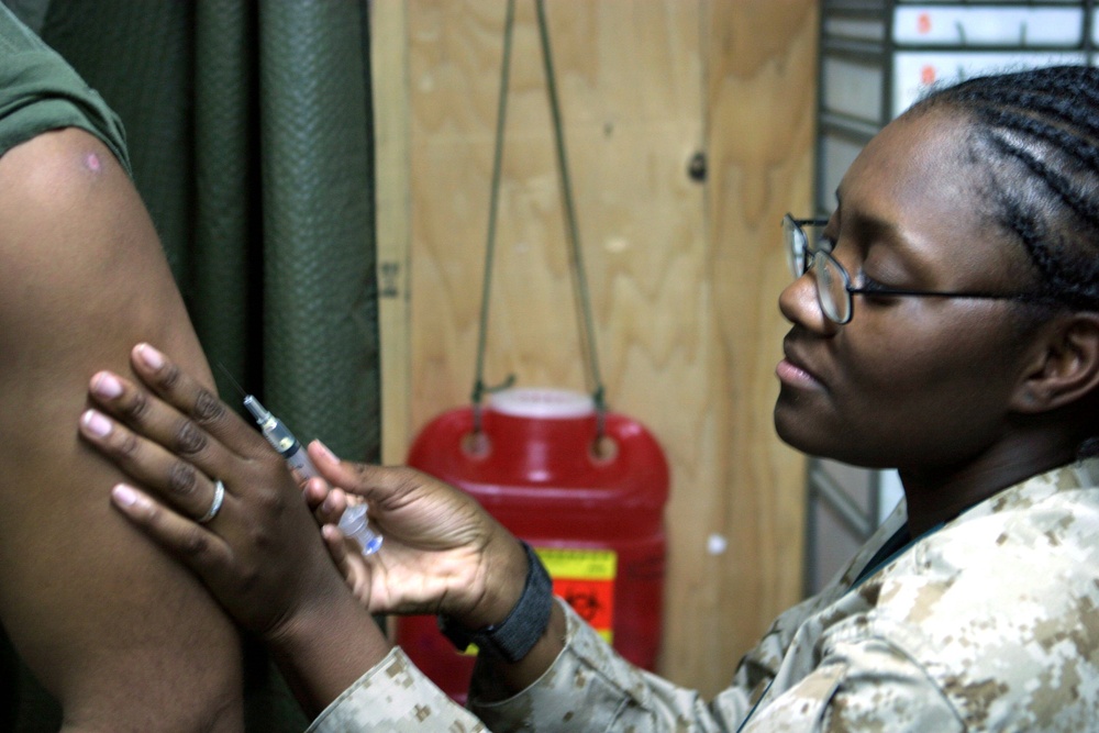 Seaman Glamourous L. Williams prepares to inject a vaccination